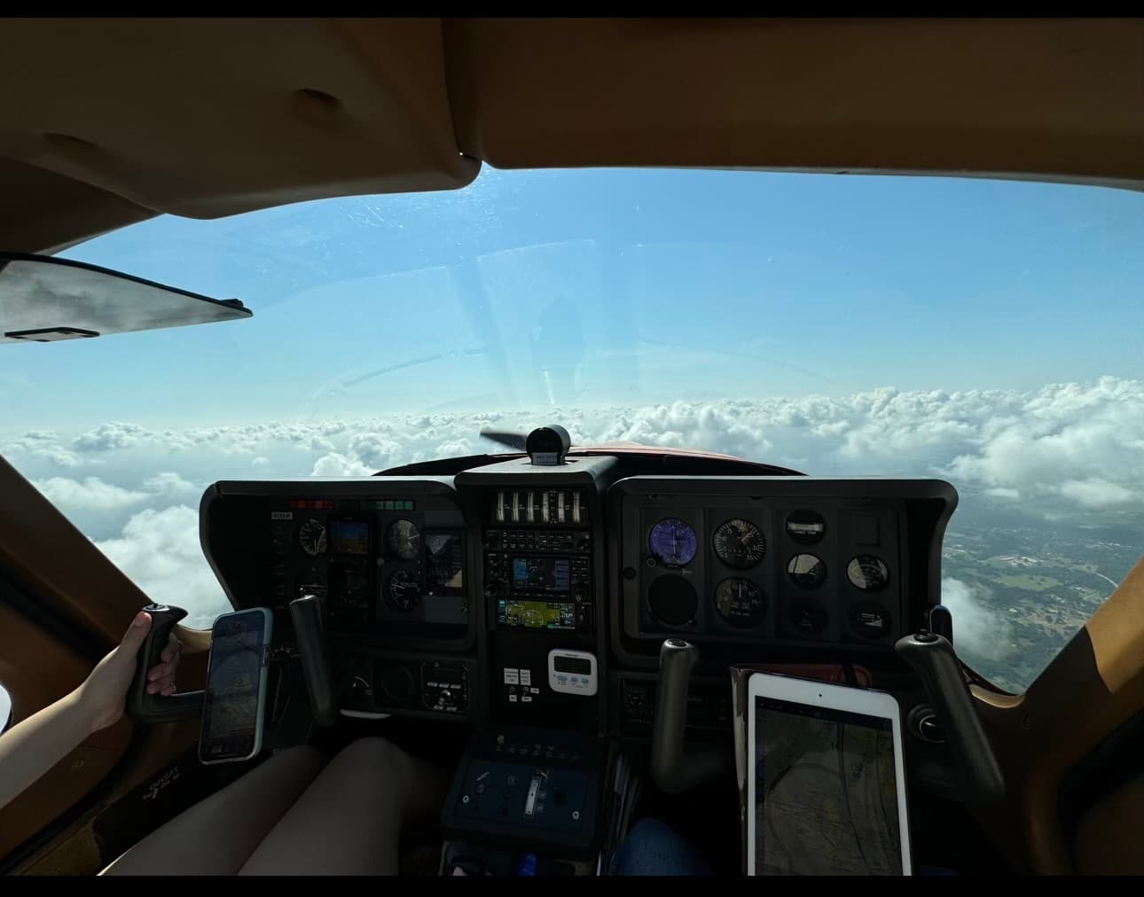 TB10 instrument panel with Garmin avionics above the clouds