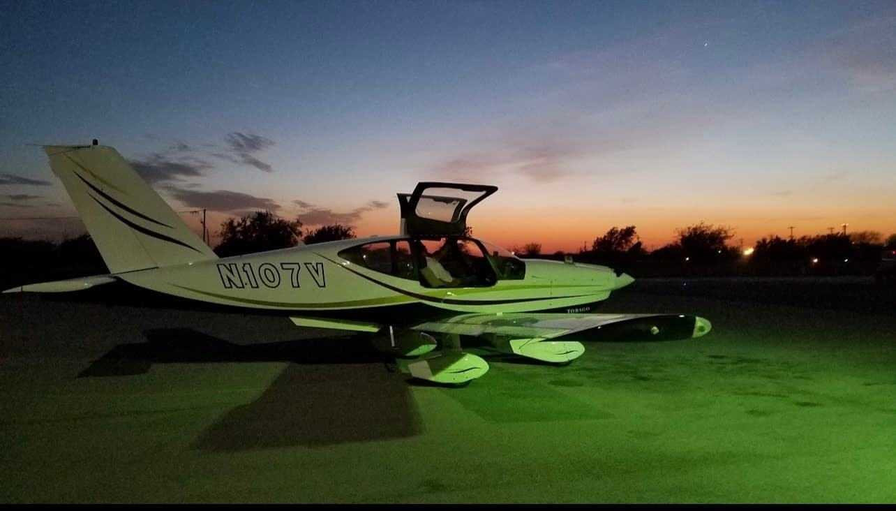 TB10 N115JR aircraft on the ramp at night