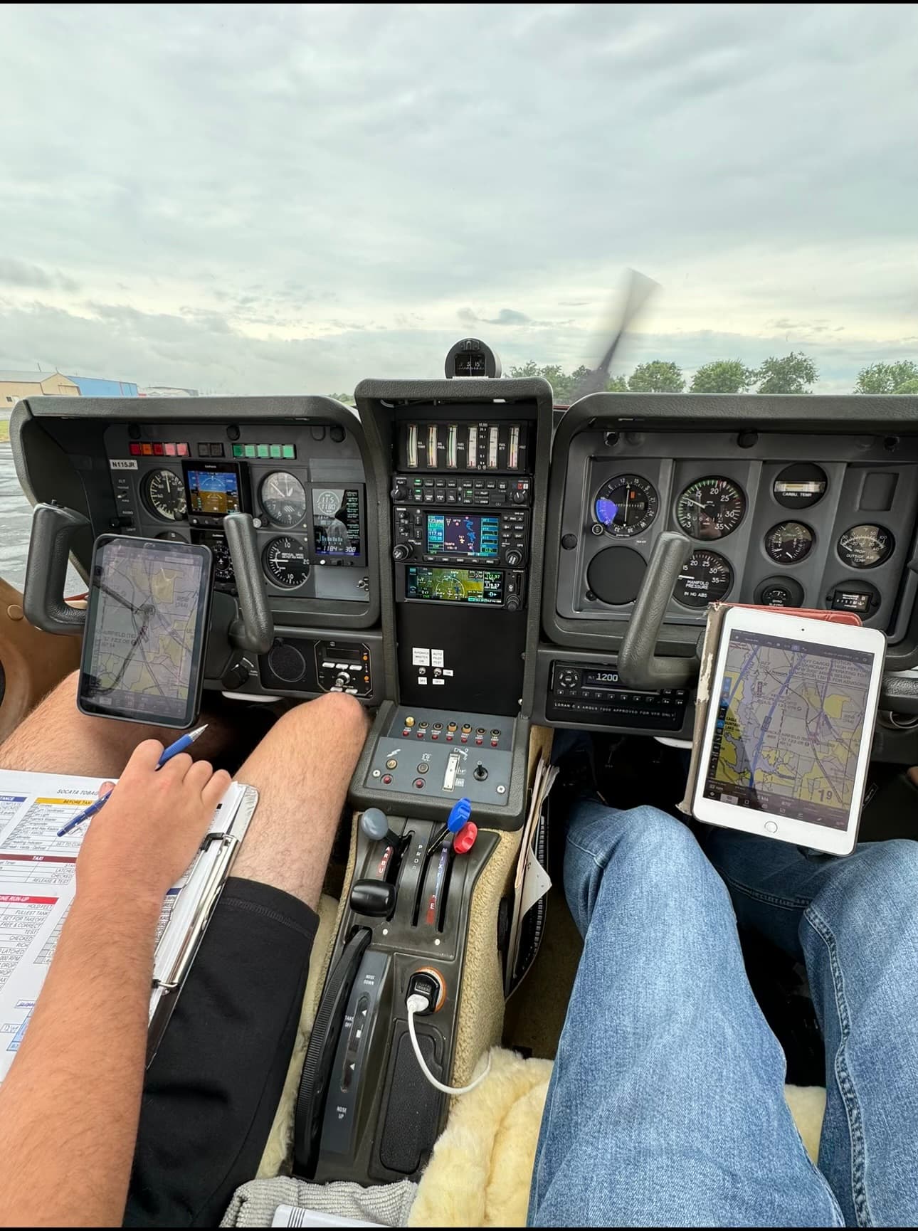 Instructor and student in the TB10 cockpit during a daytime lesson