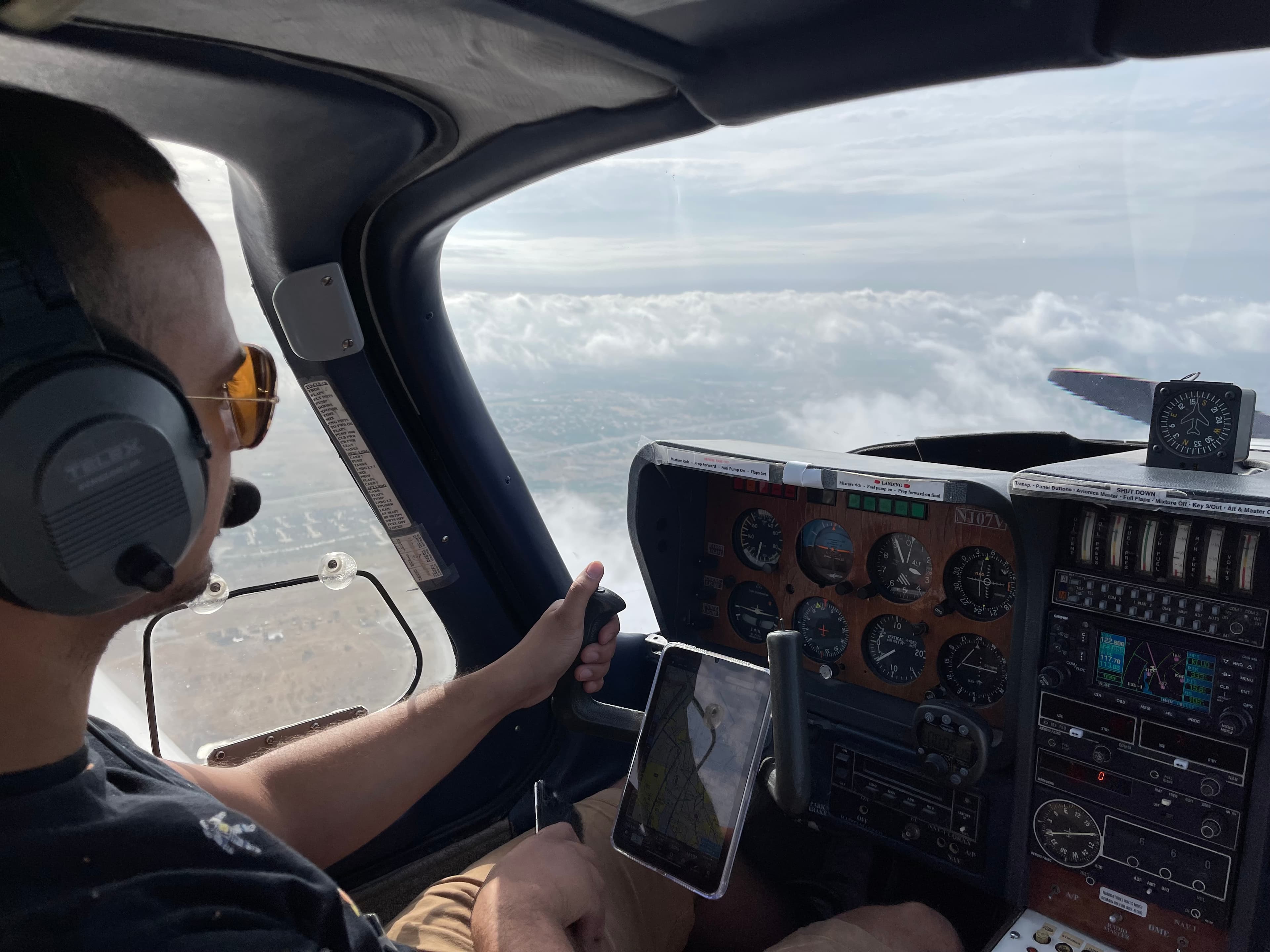 Pilot at the controls of the TB10 during a flight lesson