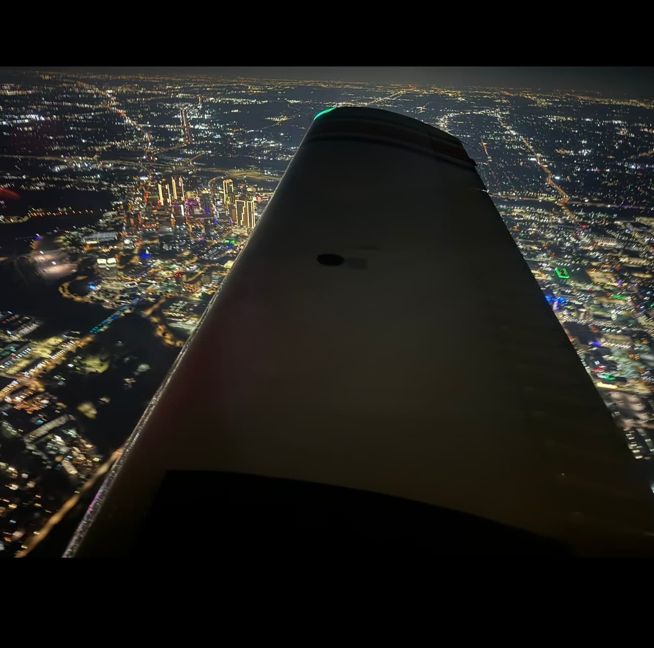 Aerial view of Fort Worth city lights at night from the TB10 aircraft
